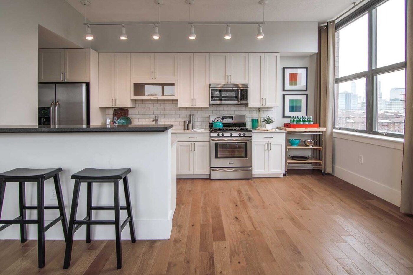 Wood plank floor running through an open kitchen